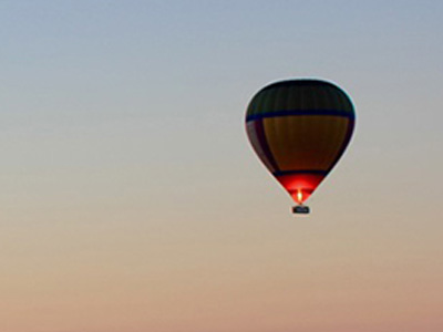 A hot air balloon in the twilight sky