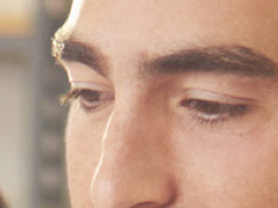 Close-up of a man's face. His eyes are focused in the distance