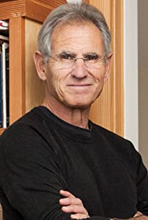 Jon Zinn in a black shirt against a wooden background