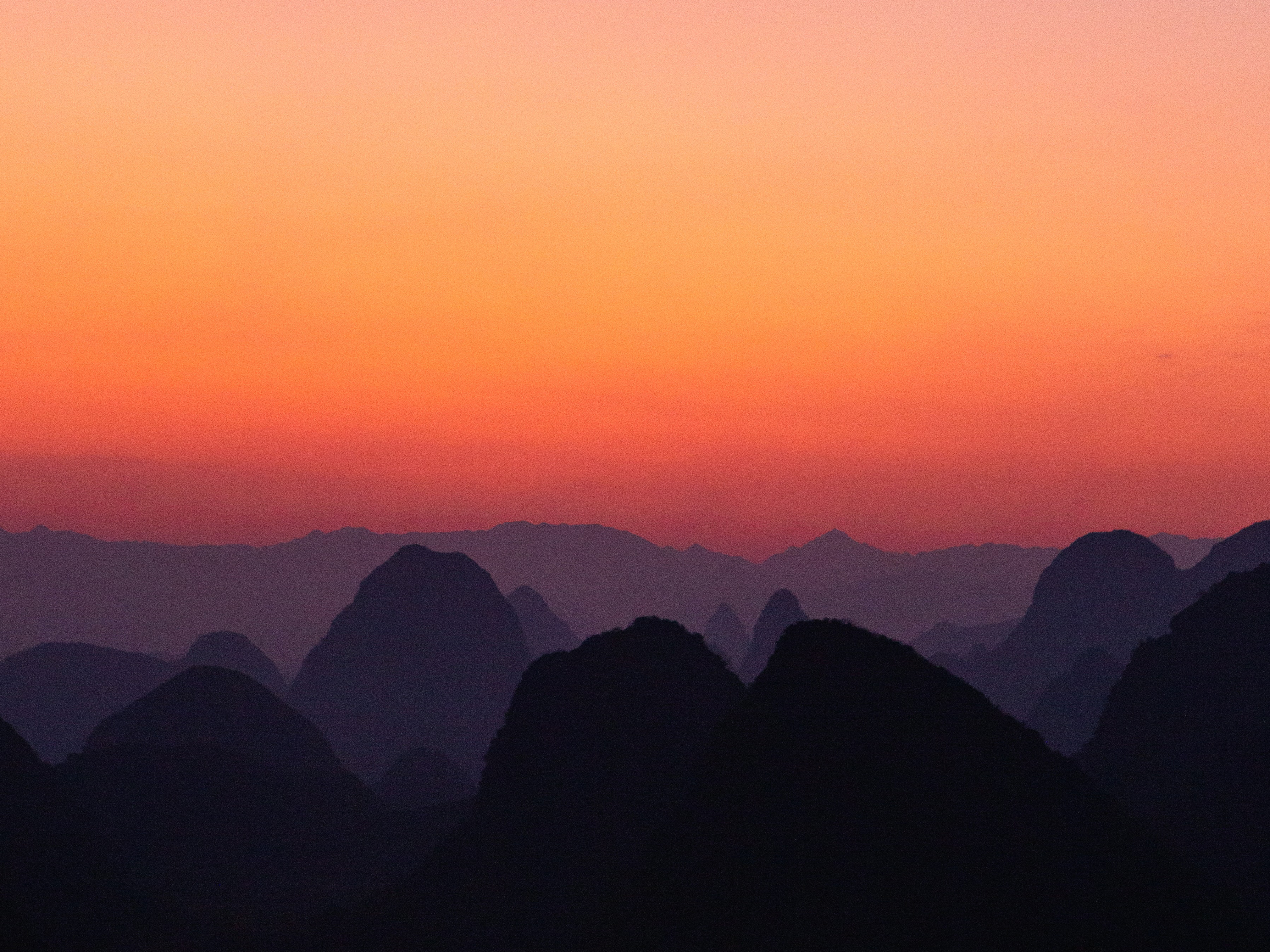 A scenic view of mountains during a sunset
