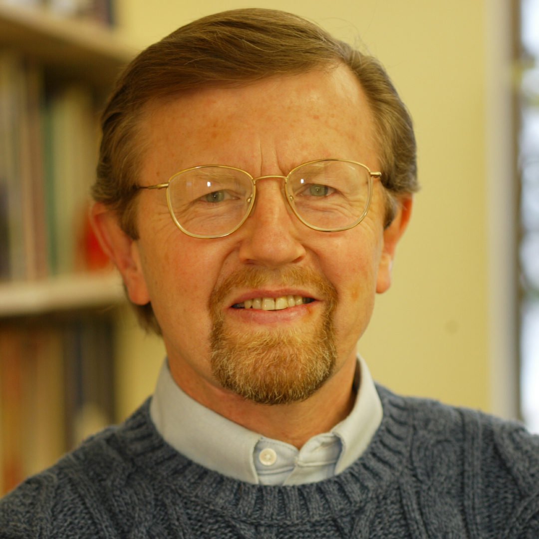Mark umbreit, a white man wearing glasses and a knit sweater
