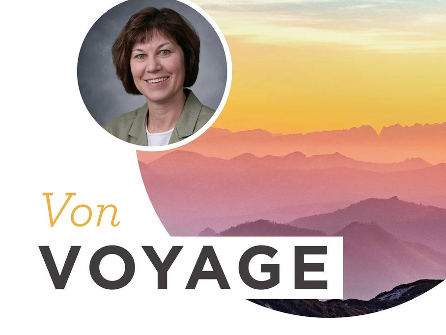 "Von voyage" text with a sunset in the background