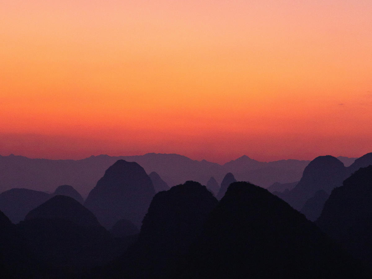 A scenic view of mountains during a sunset