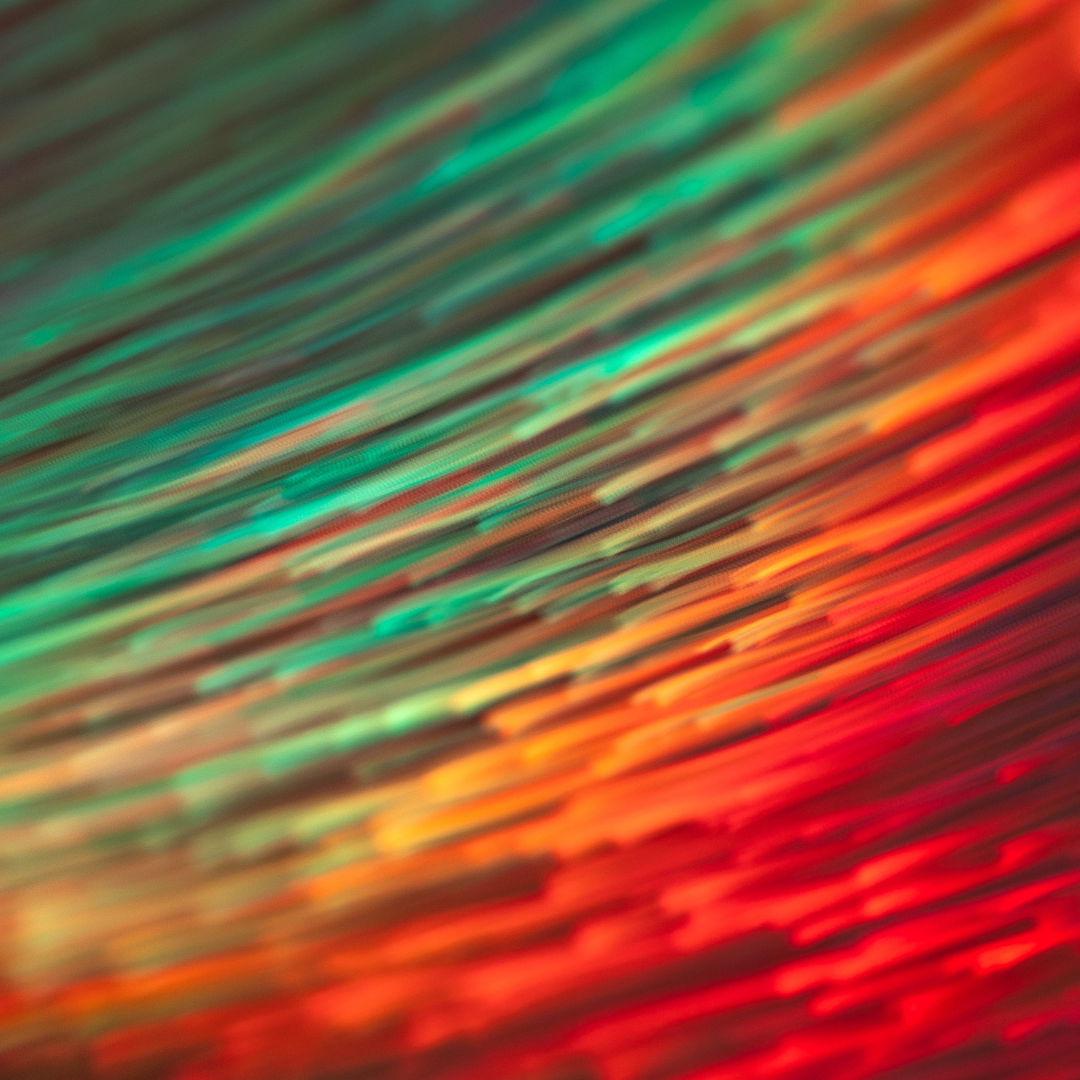 abstract art of green orange and red streaks moving in a blur