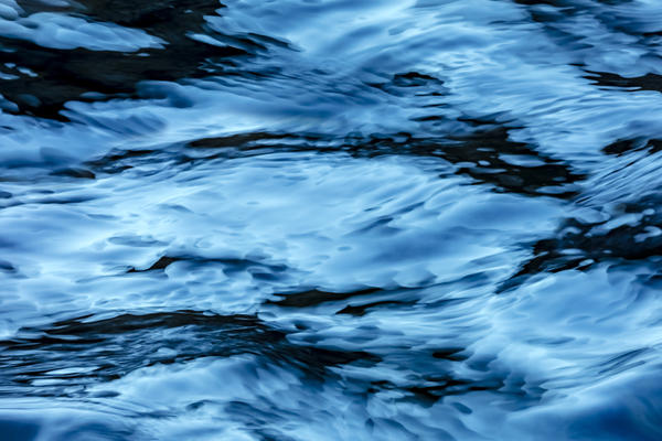 A background image of blue colored rippling water