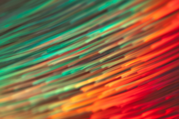 abstract art of green orange and red streaks moving in a blur